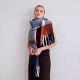 Model wearing the multicolor plaid scarf against a plain background