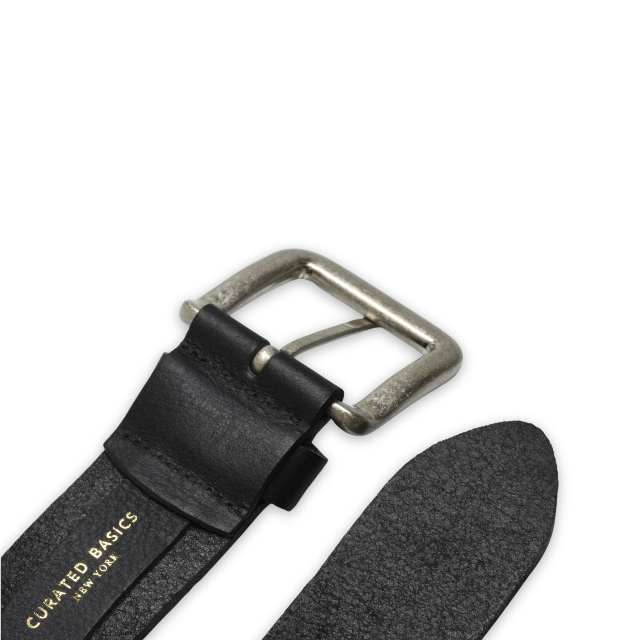 Black leather belt with silver buckle and 'Curated Basics' branding on a white background