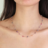 A person wearing See Real Flowers Berry Necklace with Rainbow Sapphires