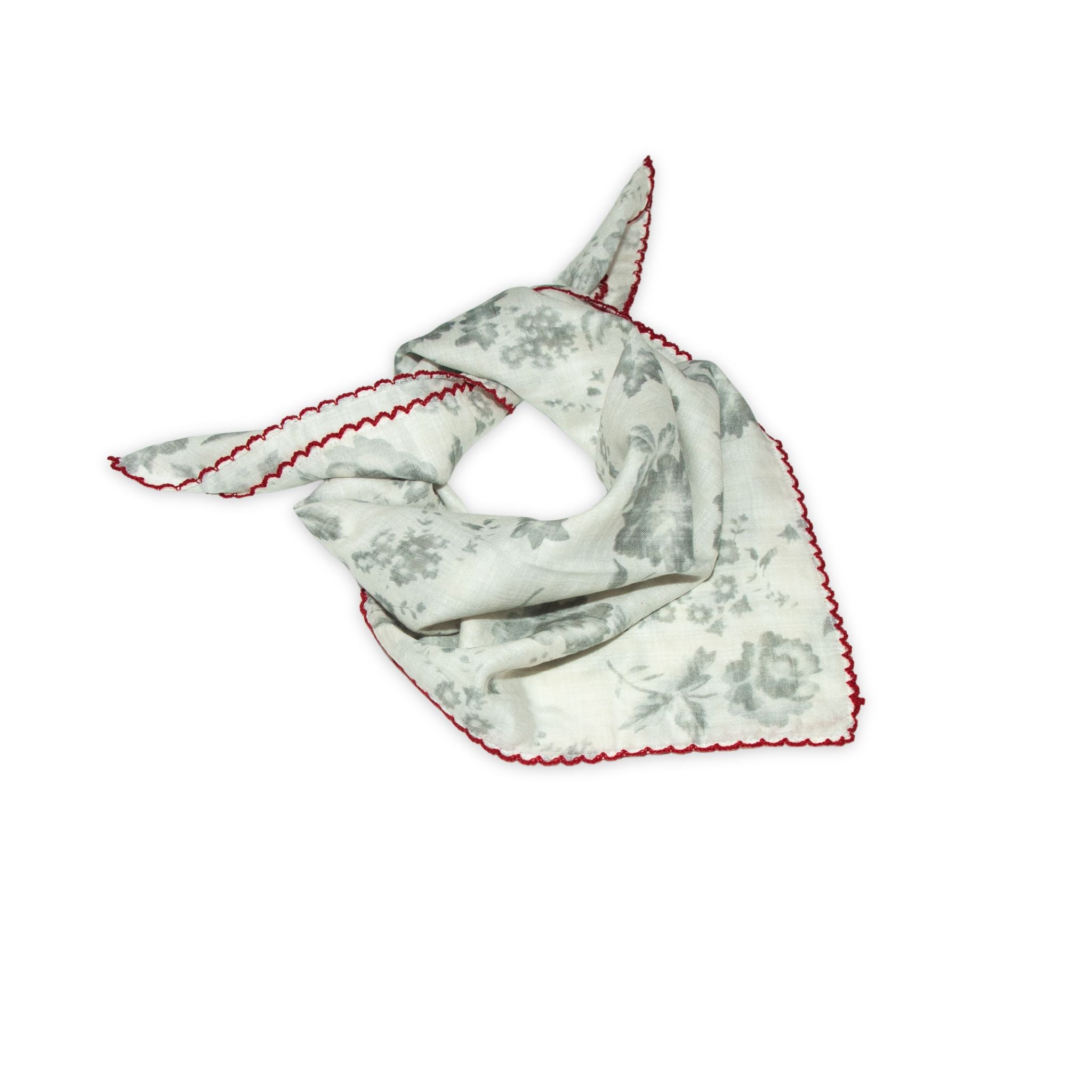 Floral patterned scarf on a white background with faded grey and deep red colors prominent