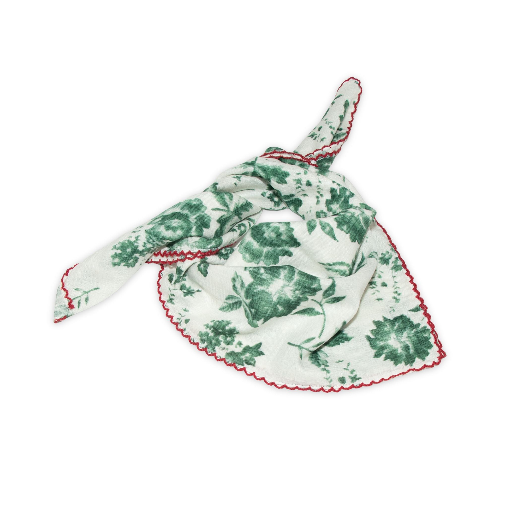 Floral patterned scarf on a white background with faded green and deep red colors prominent