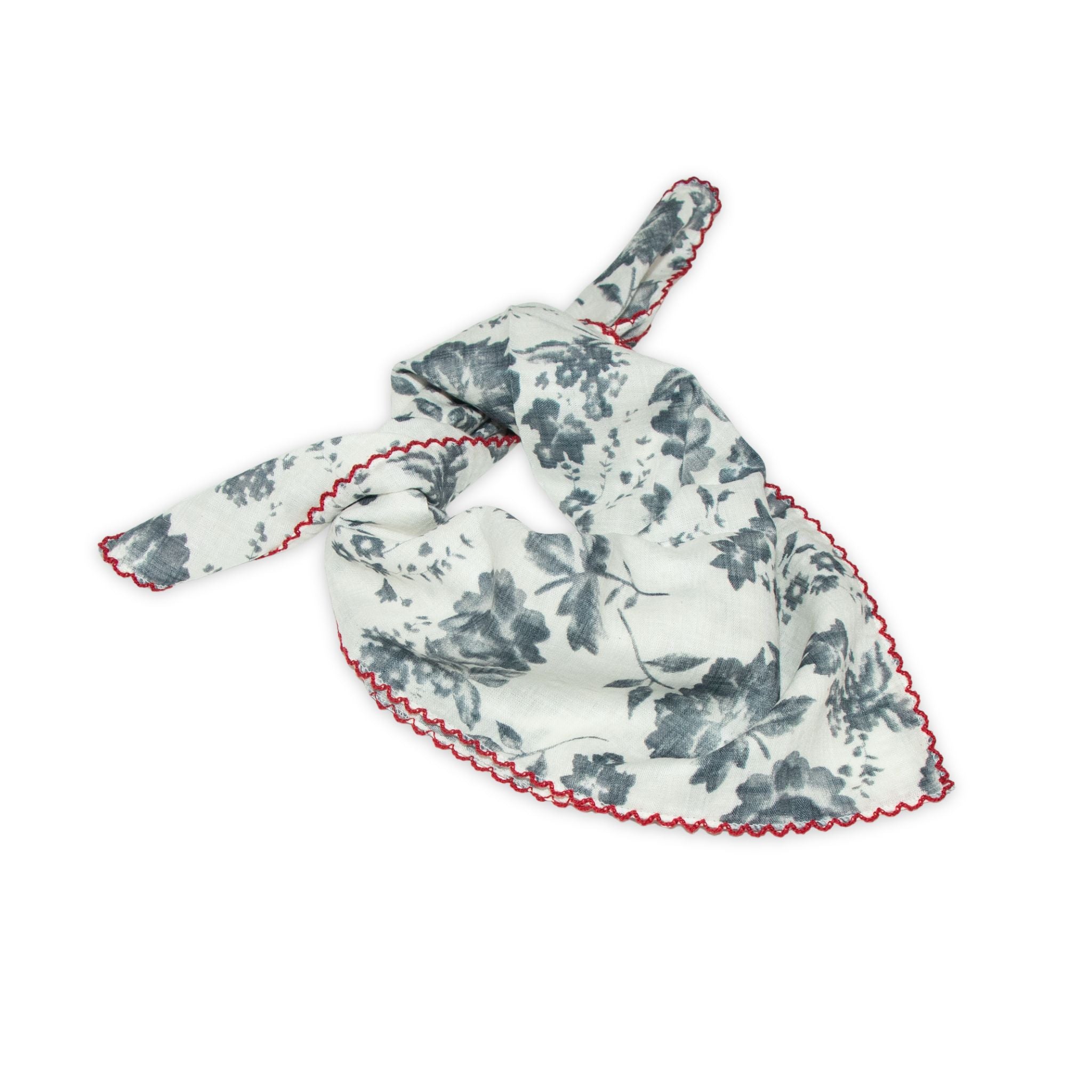 Floral patterned scarf on a white background with faded blue and deep red colors prominent