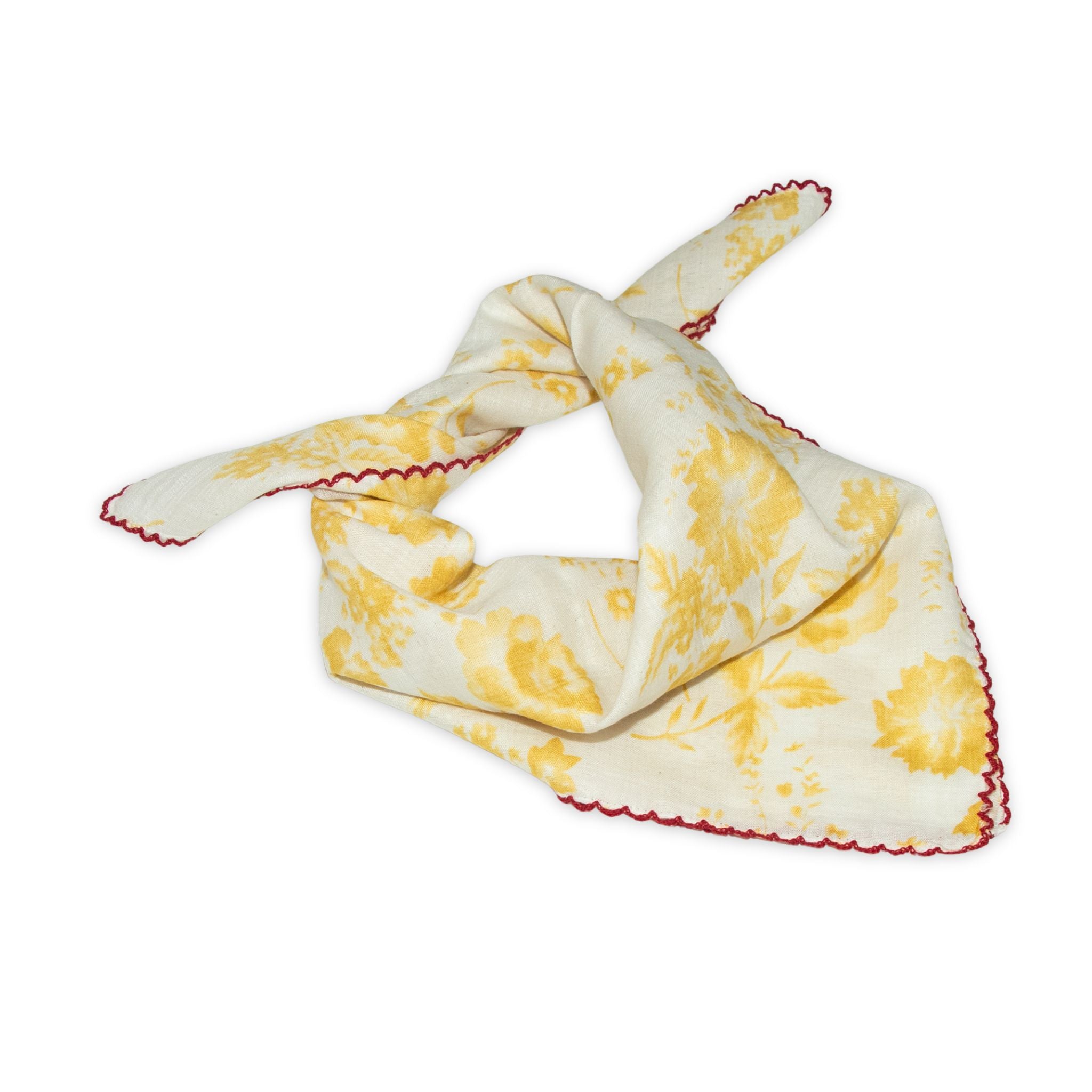 Floral patterned scarf on a white background with faded yellow and deep red colors prominent