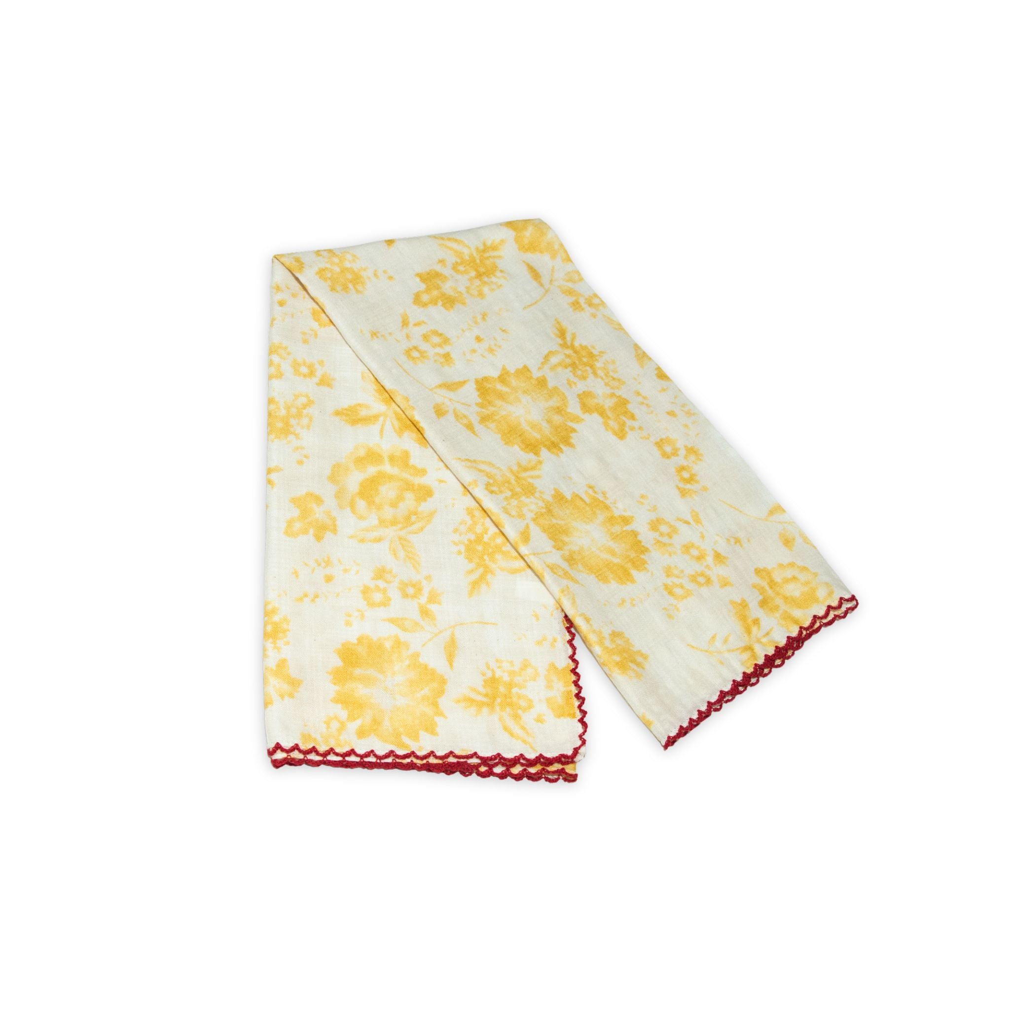 Floral patterned scarf on a white background with faded yellow and deep red colors prominent