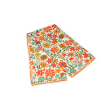 Floral patterned scarf on a white background with orange and light green colors prominent
