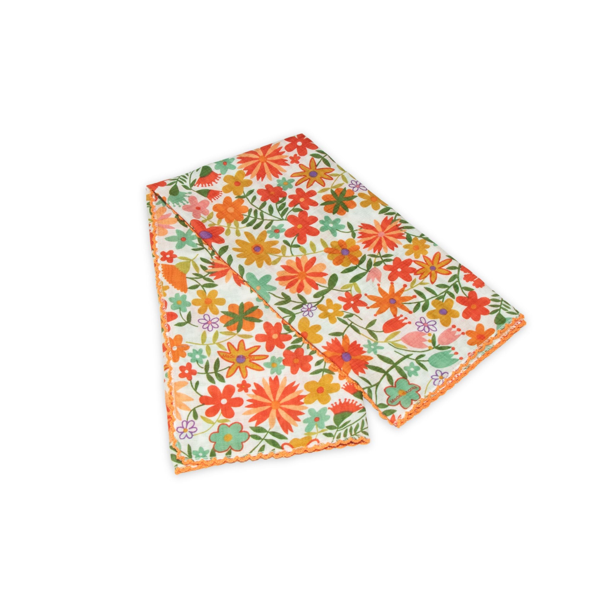 Floral patterned scarf on a white background with orange and light green colors prominent