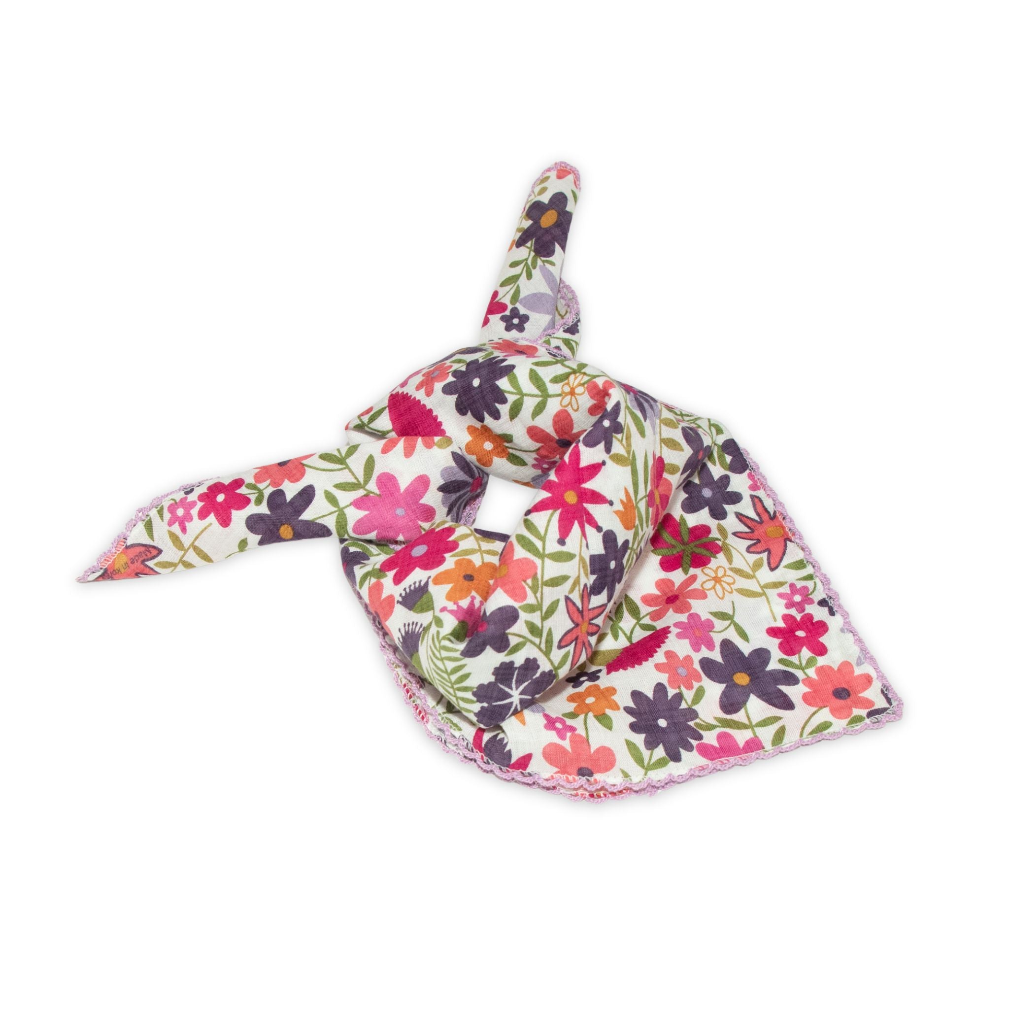 Floral patterned scarf on a white background with bright pink and lavender colors prominent