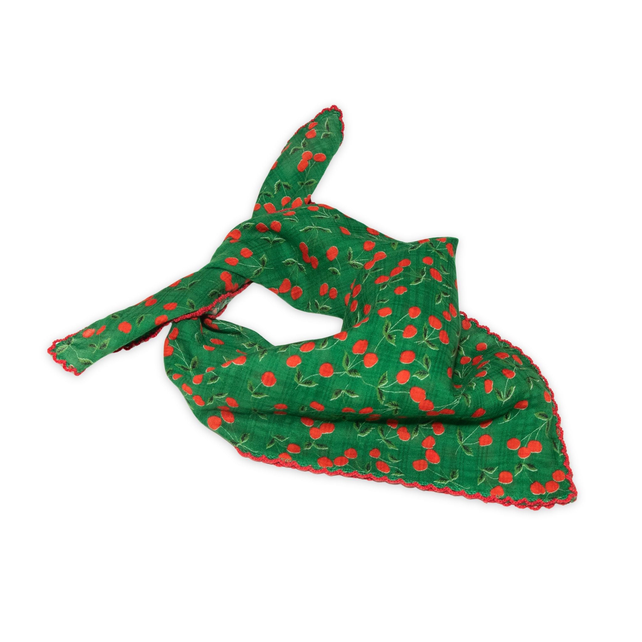 Cherry patterned scarf on a white background with red and deep green colors prominent