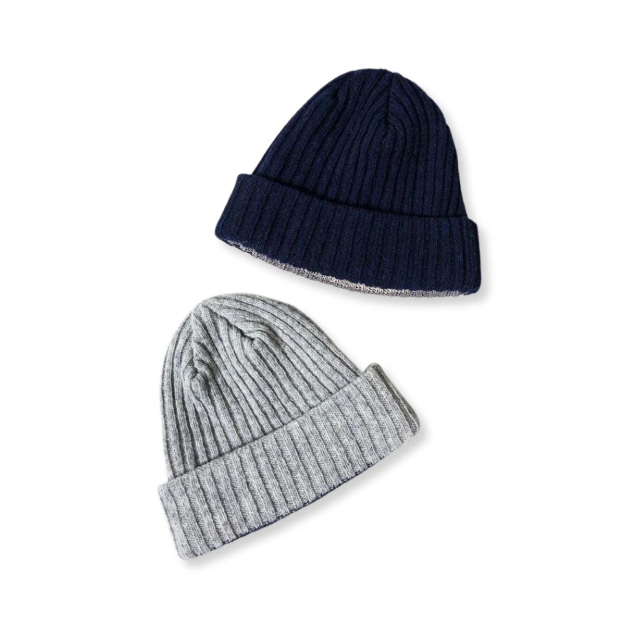 Two knit hats, one navy and one gray, on a white background