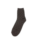 Dark brown sock with green polka dots on a white background