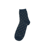 Navy sock with gold polka dots on a white background