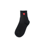 Black sock with a red heart on a white background