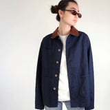 Model wearing the Nimes unisex chore blue jacket with a brown corduroy collar on a white background