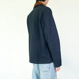 Model wearing the Nimes unisex chore blue jacket with a brown corduroy collar on a white background