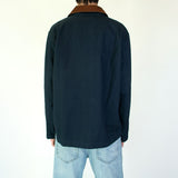 Model wearing the Nimes unisex chore blue jacket with a brown corduroy collar on a white background