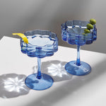 lifestyle image of image of two fazeek champagne glasses blue color filled with liquid