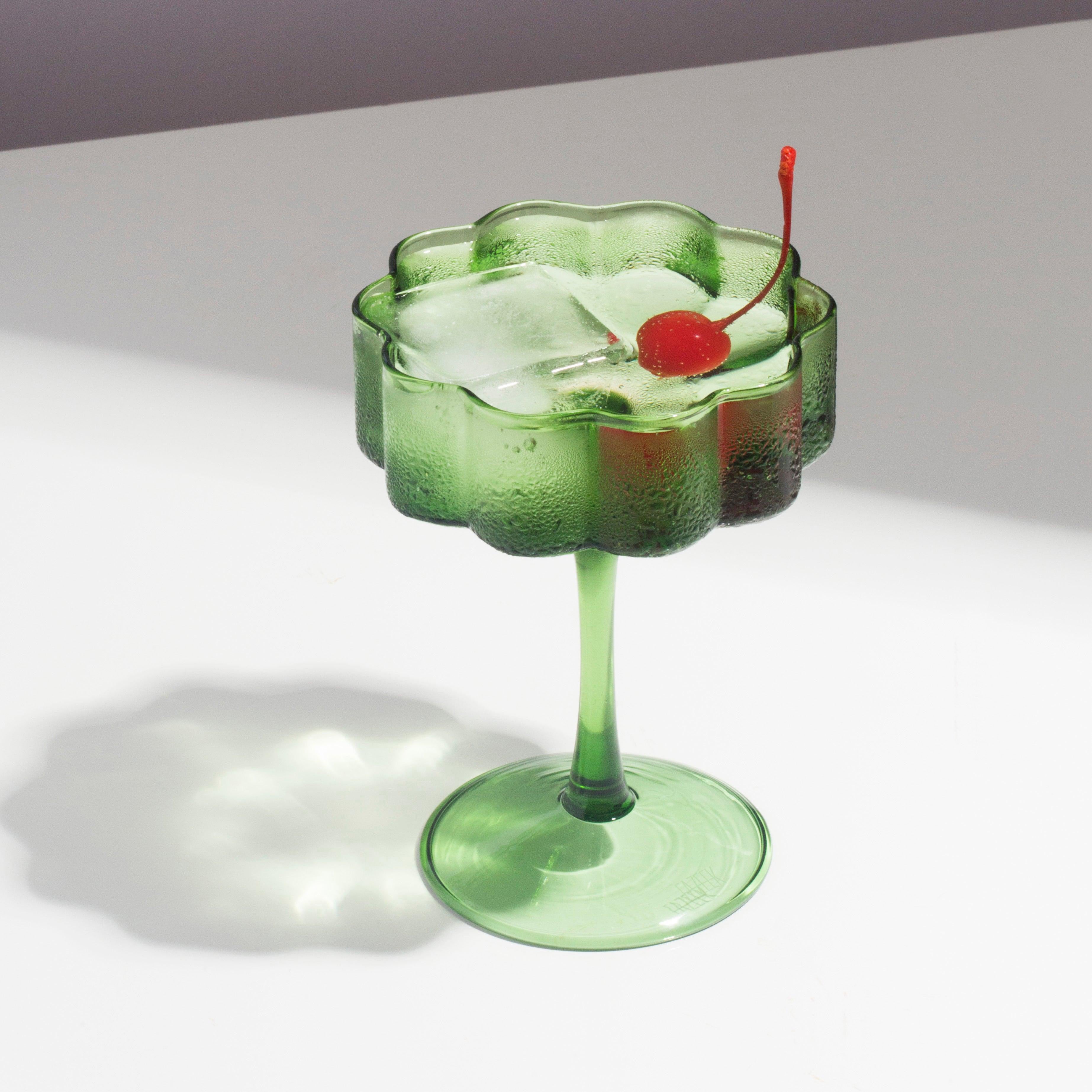 Image of Fazeek's Green Coupe Glass w/ a cold drink and a cherry on top