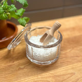 image of home eat drink earth nest salt dish open with wooden scoop and filled with salt