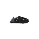 Side view of black slipper with white polka dots on a white background