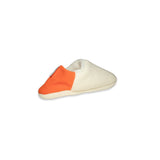Angled view of creme  slipper with orange on a white background