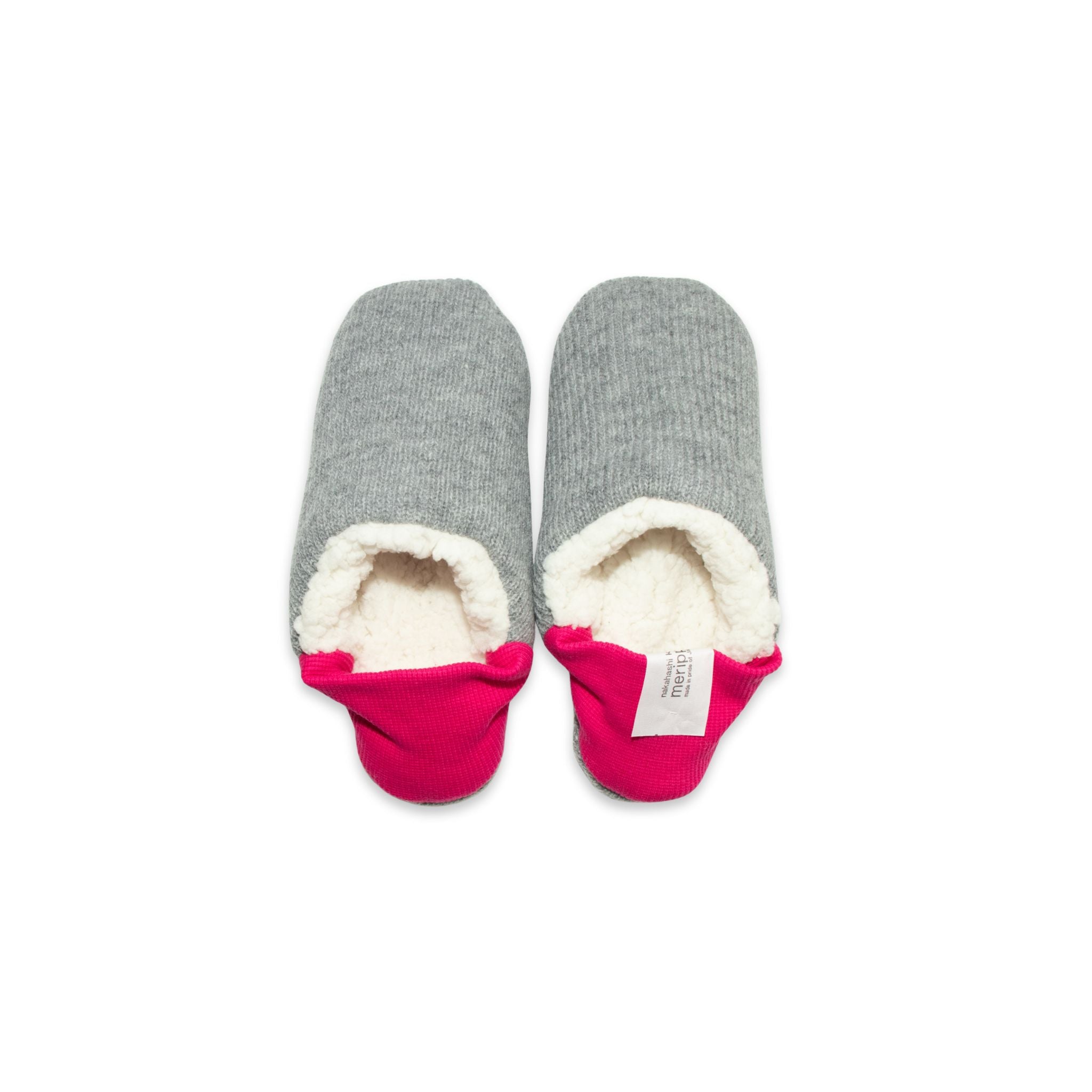 A pair of dark grey colored  slippers with pink trim on a white background