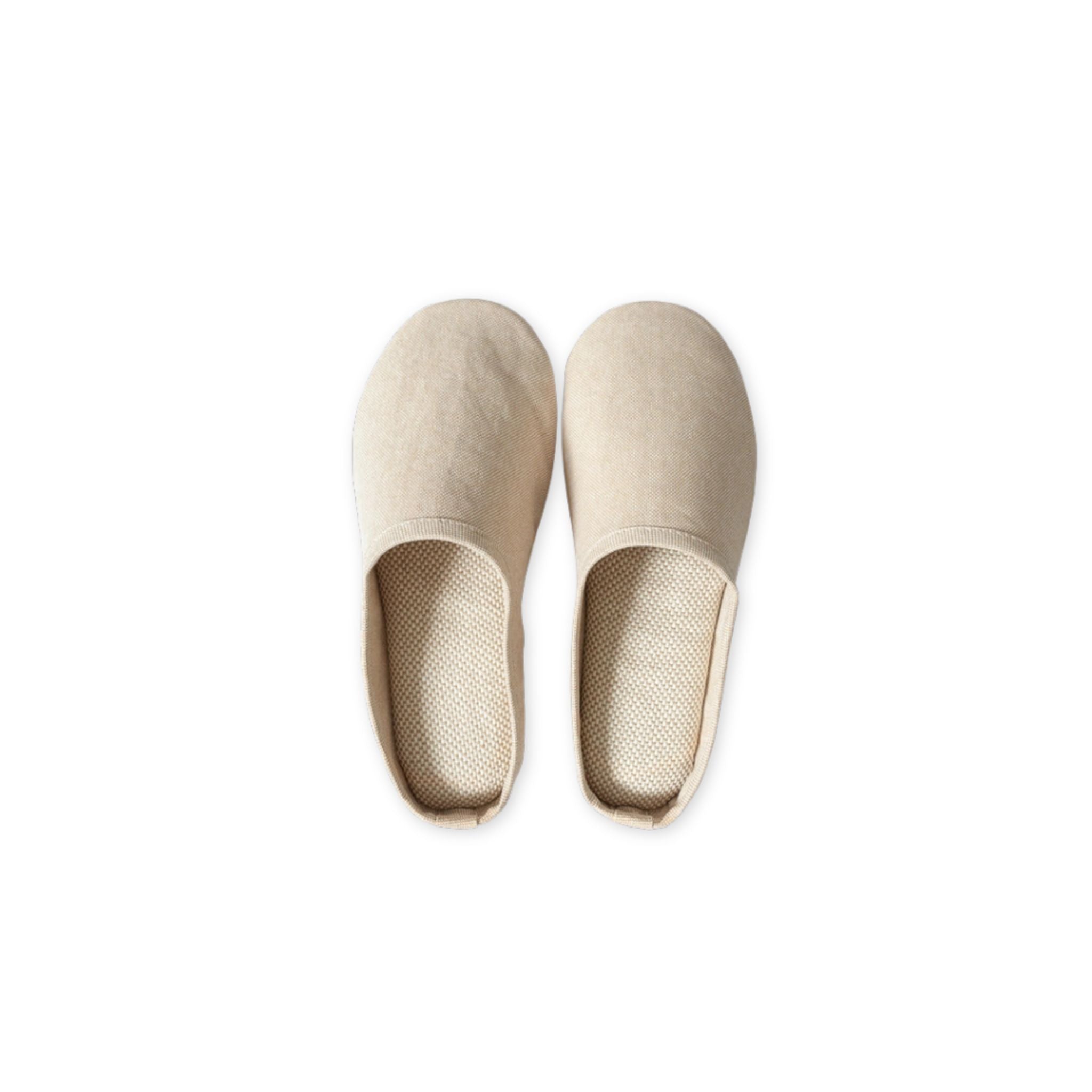 Pair of beige slippers on a white background
