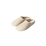 Pair of beige slippers on a white background
