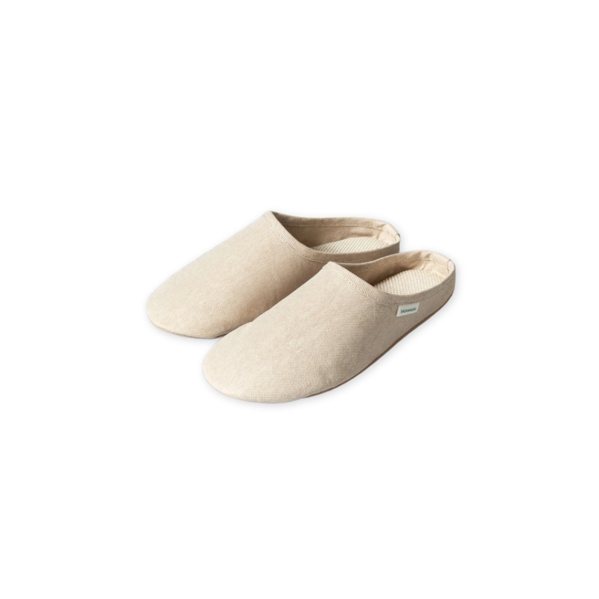 Pair of beige slippers on a white background