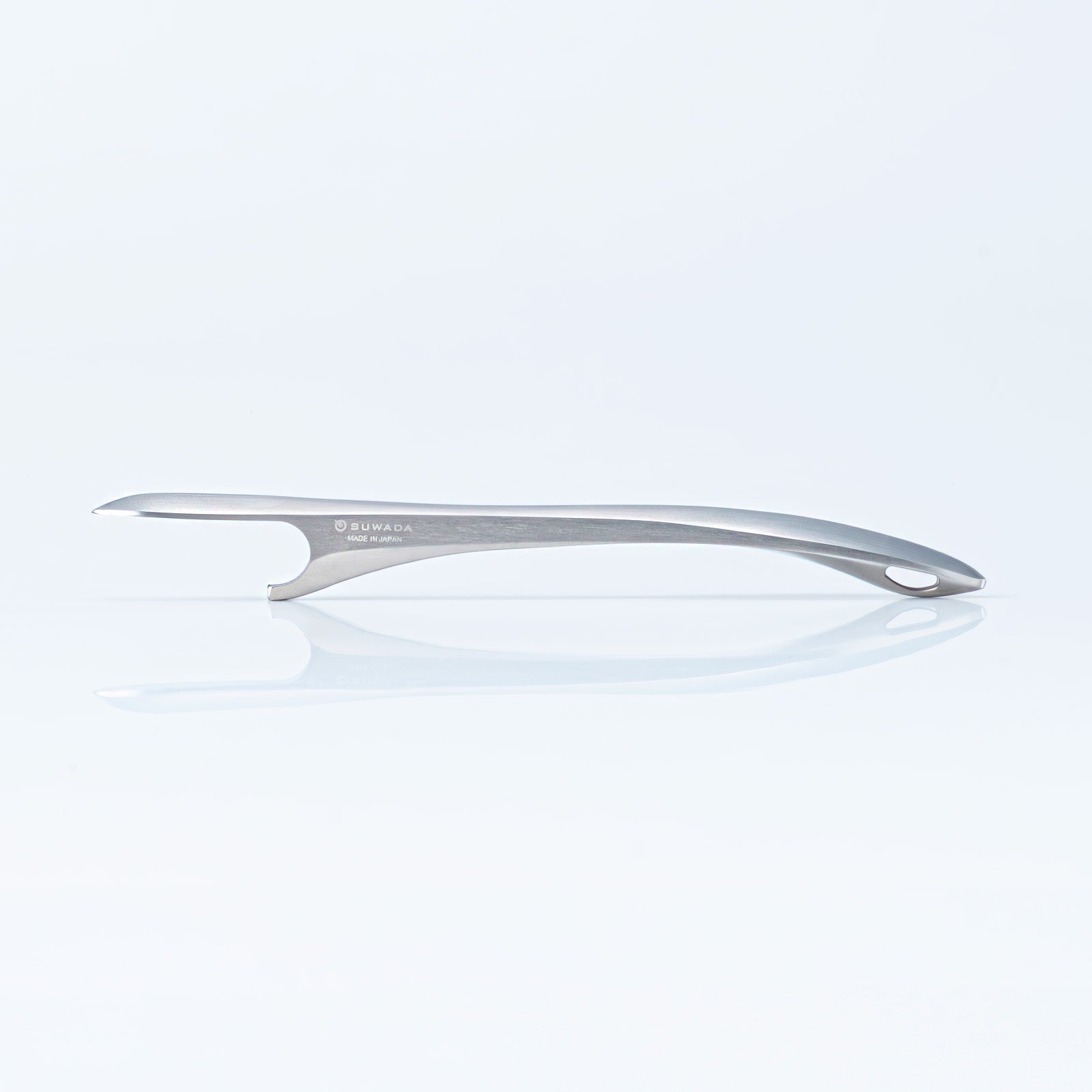 Side view of the Suwada brushed stainless steel bottle opener with a satin finish on a blue tinted background