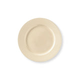 Beige ceramic plate with textured rim on a white background