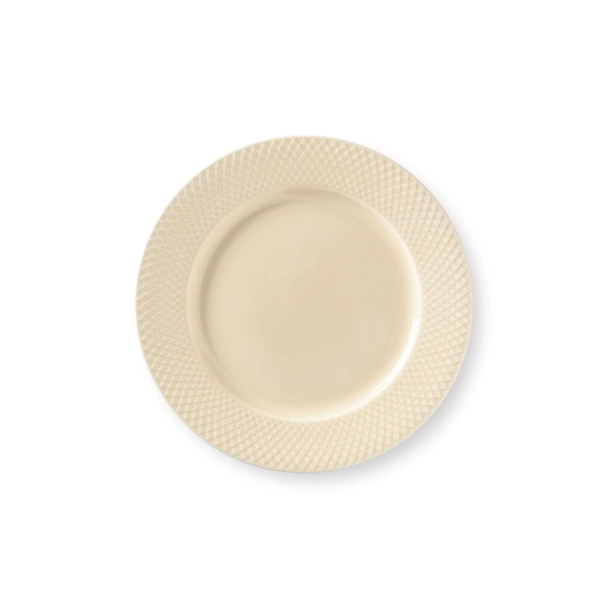Beige ceramic plate with textured rim on a white background
