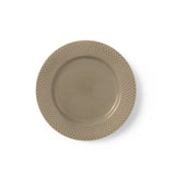 Beige ceramic plate with textured rim on a white background