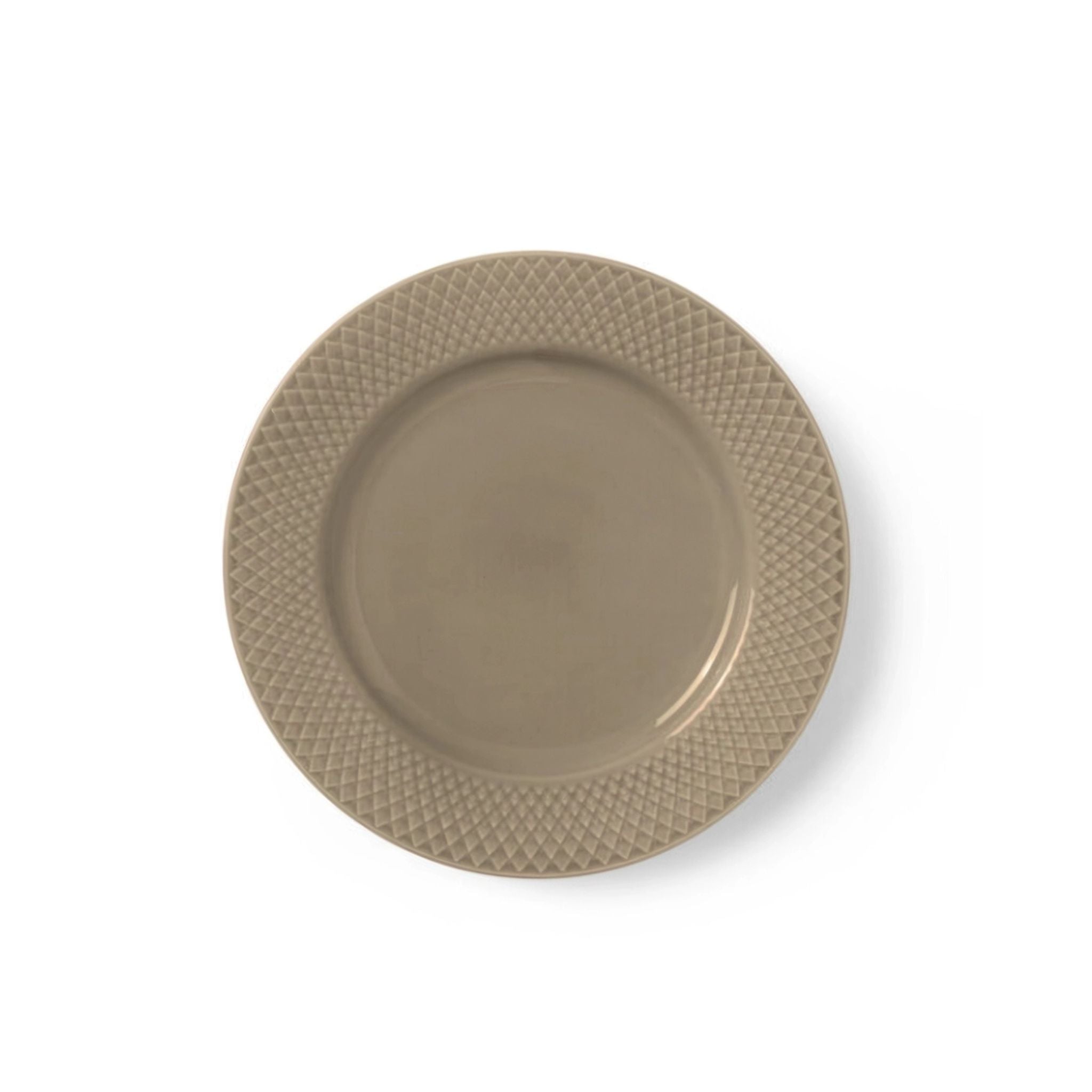 Beige ceramic plate with textured rim on a white background