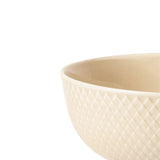 Beige ceramic porcelain bowl with textured surface on a white background