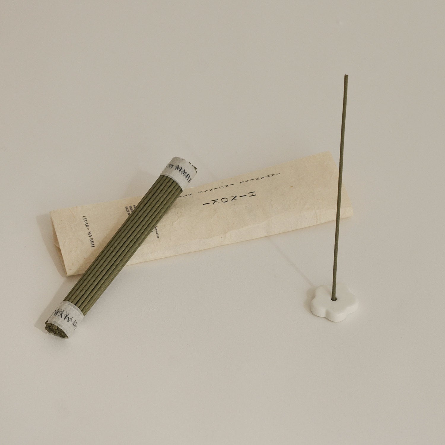 Incense stick and packaging on a beige background