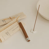 Incense sticks with a small dish on a light surface
