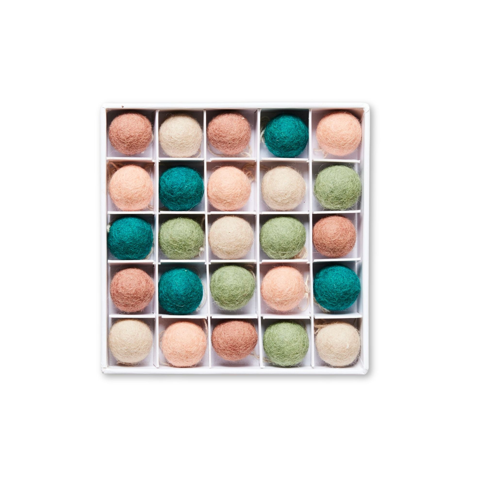 A neatly arranged box of 25 felted wool balls in soft, natural tones of teal, sage green, cream, blush, and brown. Each ball is placed in its own white compartment, creating a grid-like pattern with a cozy, handcrafted feel.