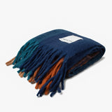 Folded plaid throw with fringes and brand label Arctic Fox on a white background