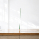 KUSA object on a wooden surface with a white background