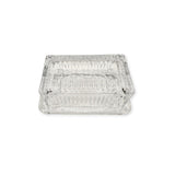 Clear glass beurre dish on a white background