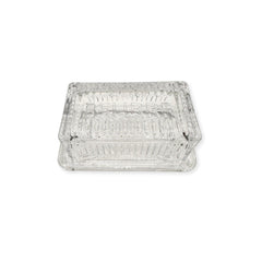 Clear glass beurre dish on a white background