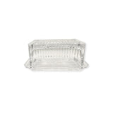 Clear glass beurre dish on a white background