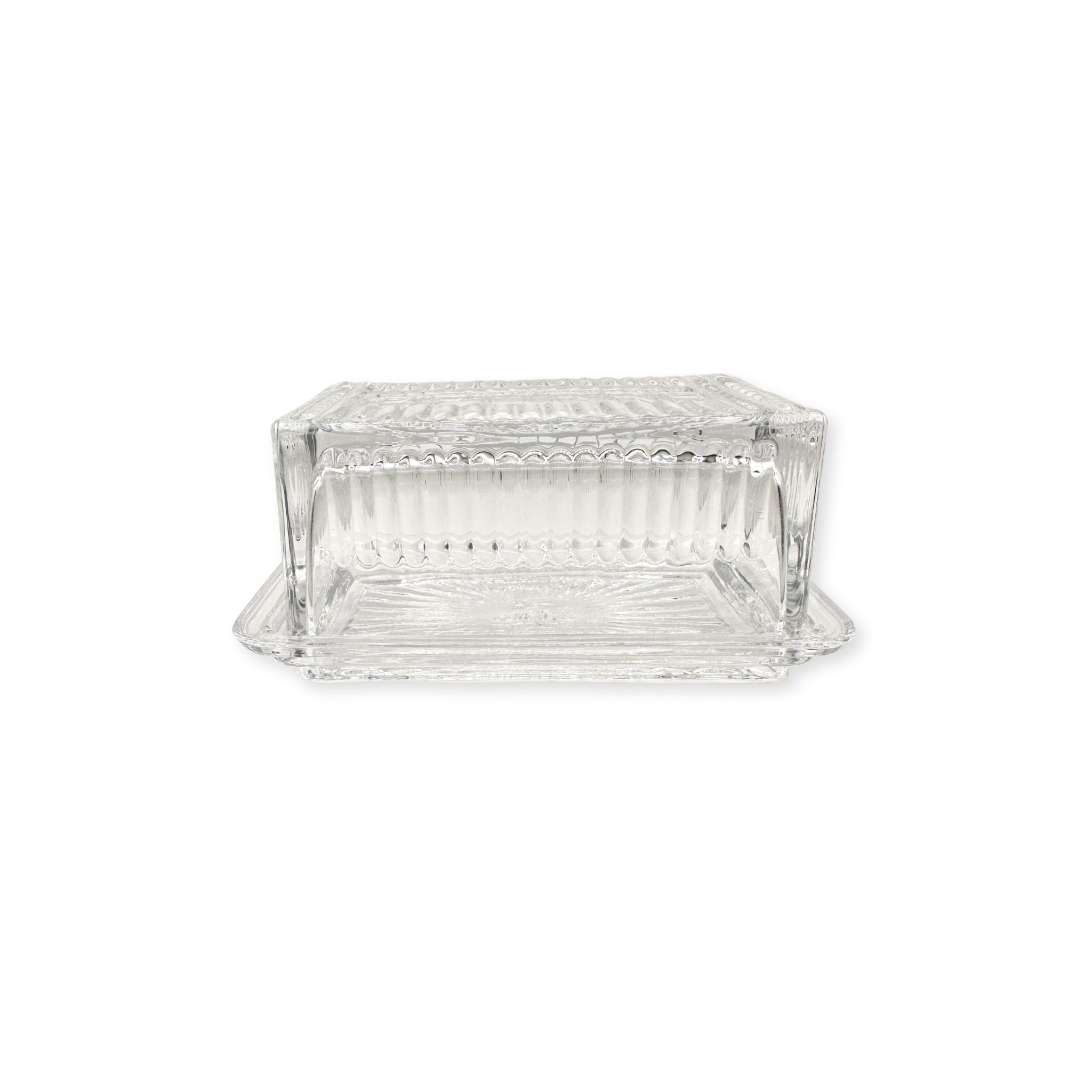Clear glass beurre dish on a white background