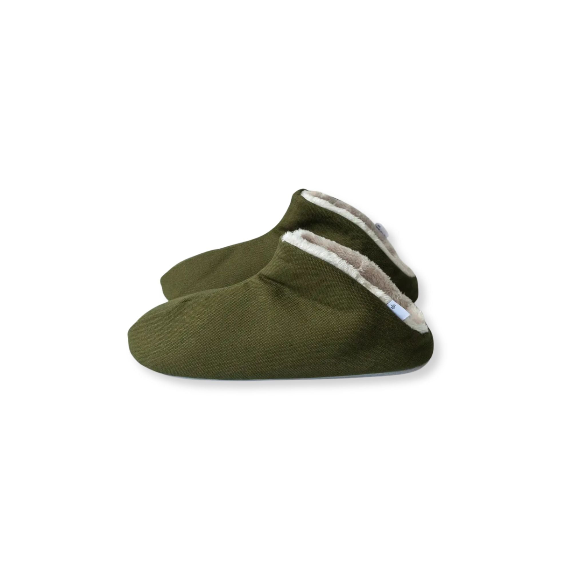 Pair of green slippers with white lining on a white background