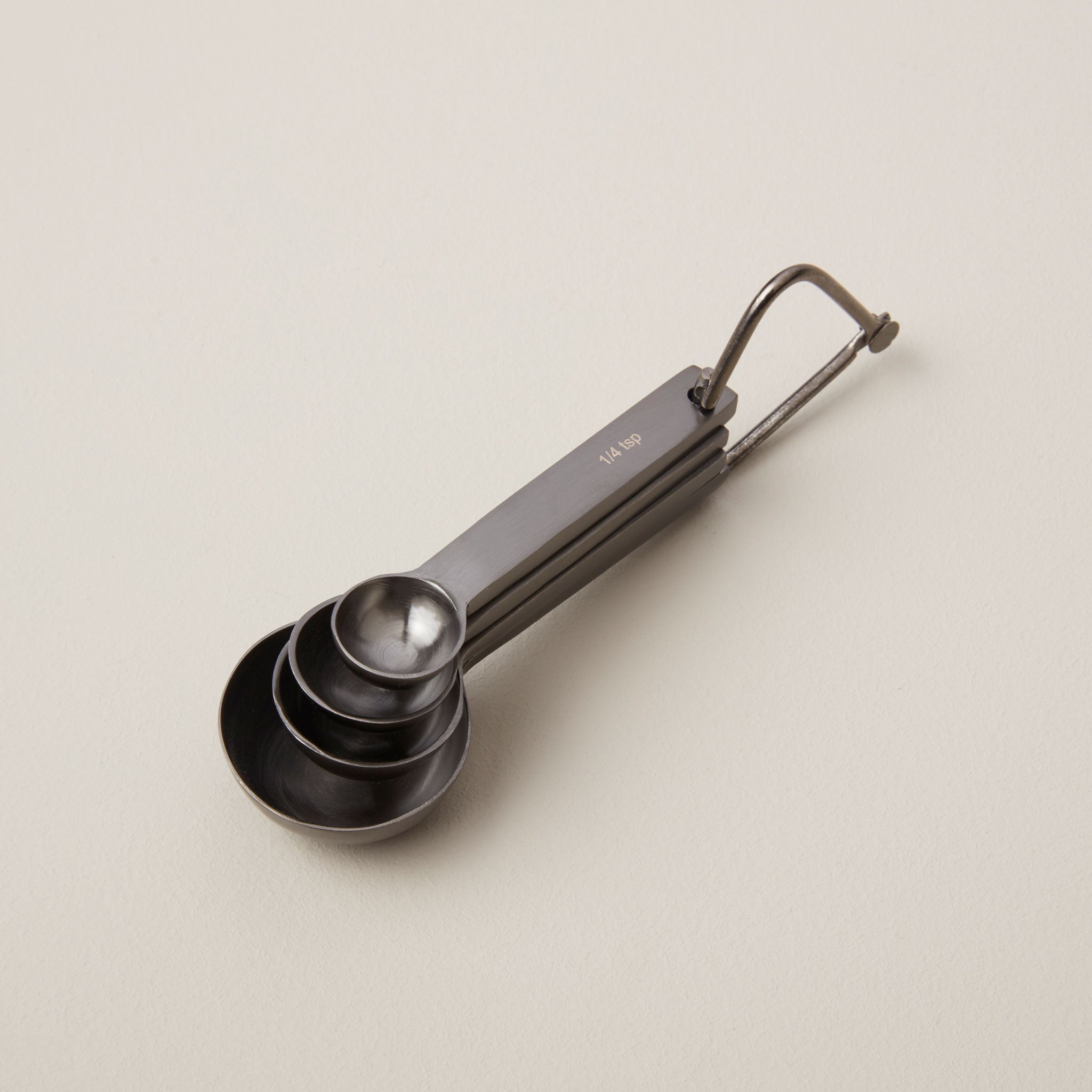 Set of metal measuring cups on a beige background