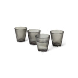 Four smoked gray glass tumblers on a white background