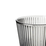 Closeup of smoked gray glass tumbler on a white background