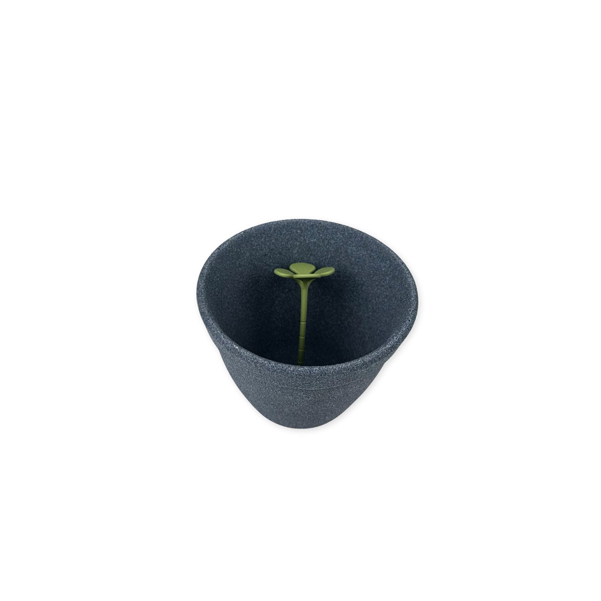 Top angled view of Kinome coffee filter with green measurement tool  on a white background