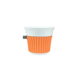 White mug with an orange ribbed pattern on a white background
