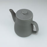 Gray ceramic teapot on a white background